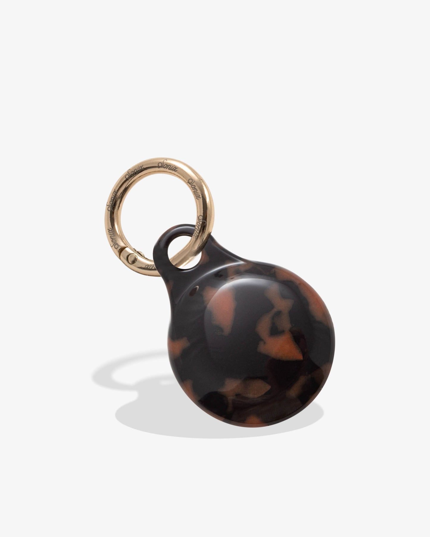 plastic airtag cover in brown tortoise