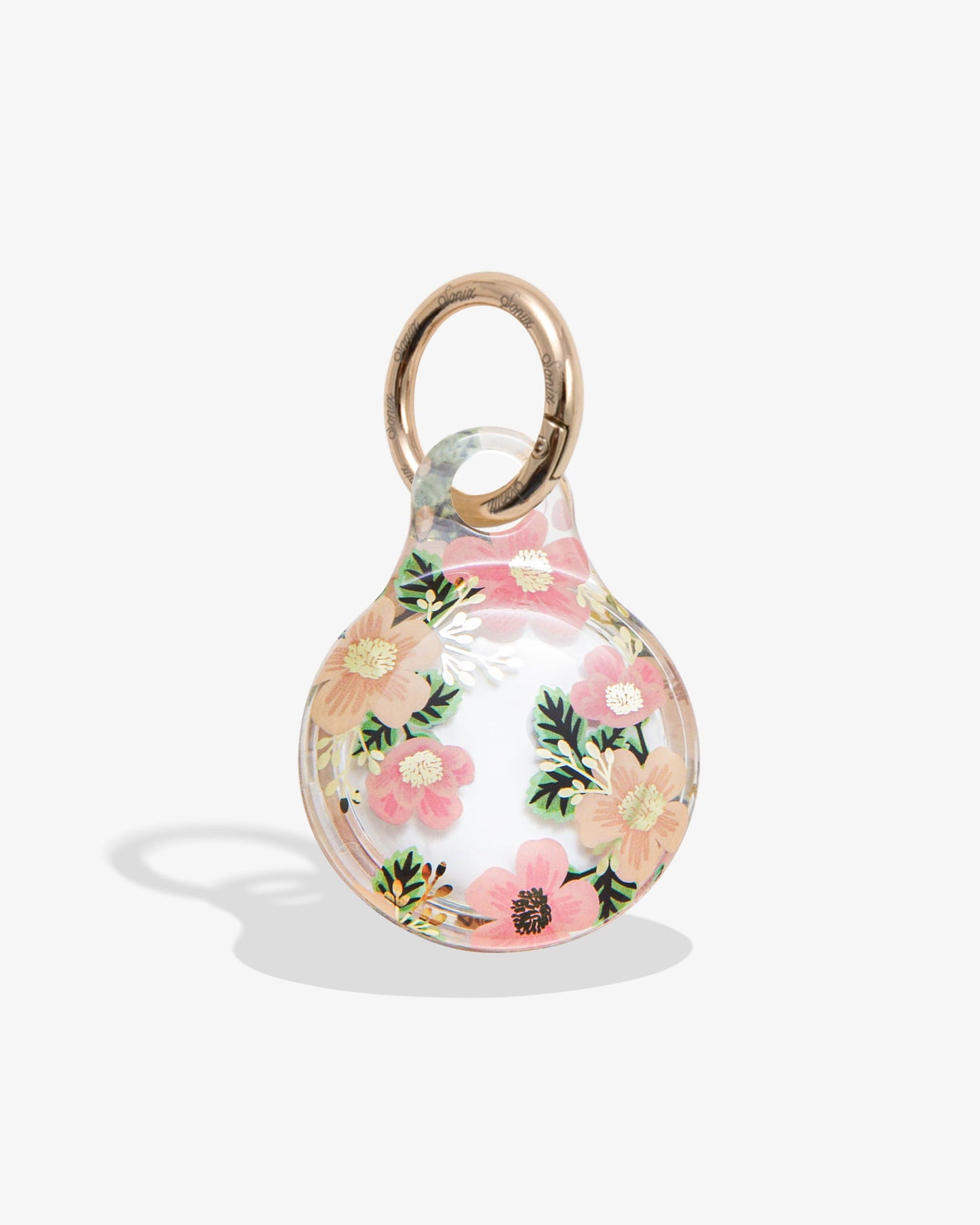 clear airtag cover with pink and orange flowers, green leaves and gold foil details with gold ring