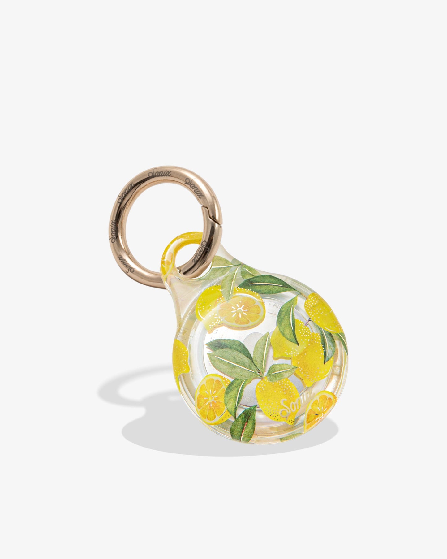clear airtag cover with yellow lemons and green leaves with gold ring