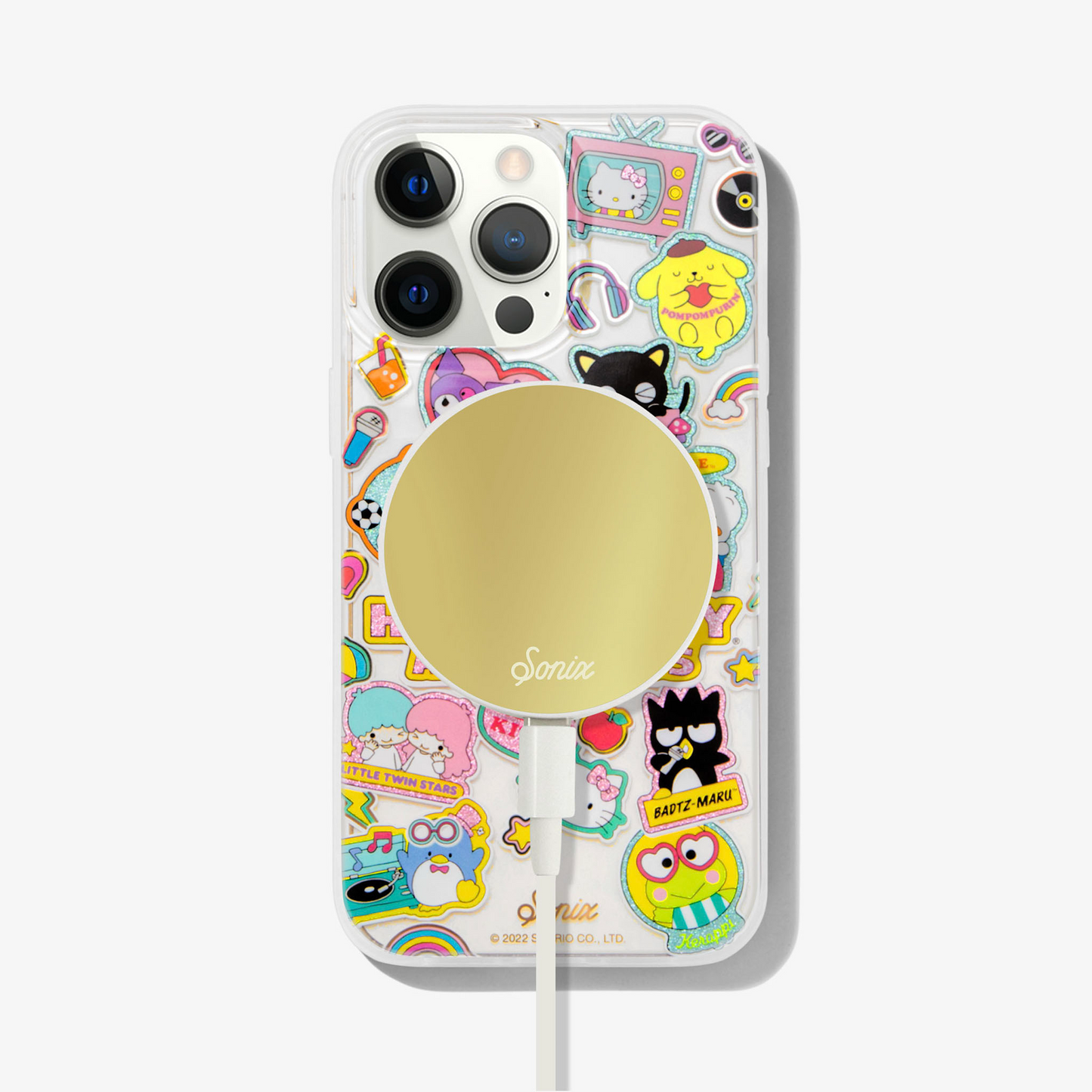clear case with many beloved hello kitty characters featuring multi-color glitter and classic gold foiling shown on an iphone 13 pro max with a gold maglink charger on the back