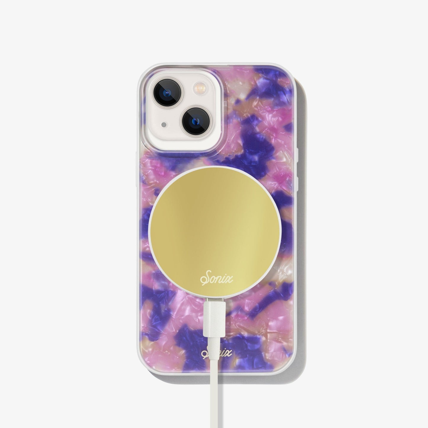 hazy illusion of pink, purple, and orange to create an appearance of a colorful mirage shown on an iphone 13 with a gold maglink charger on the back