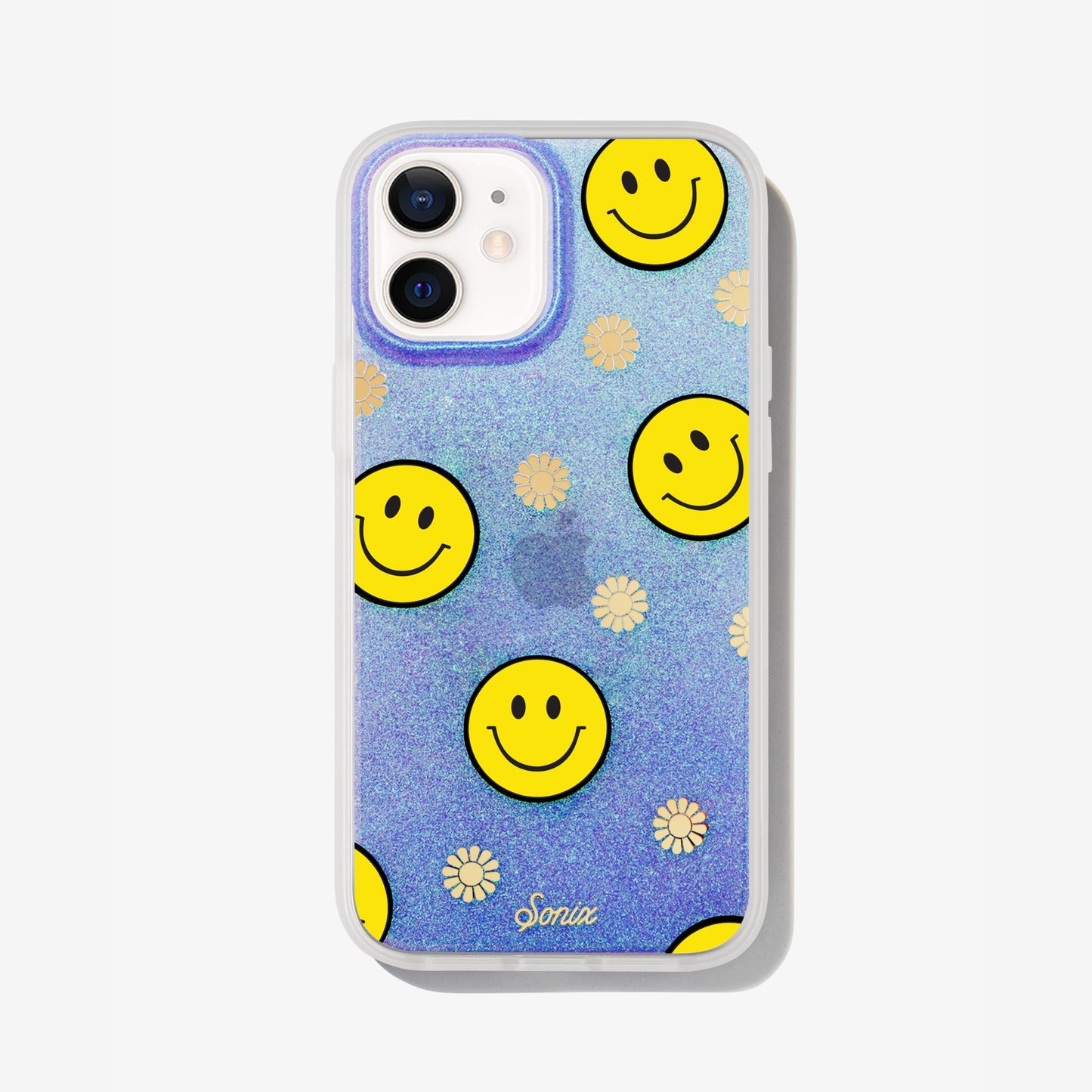 The clear purple case infused with iridescent glitter features happy faces and signature gold foil flowers shown on an iphone 12