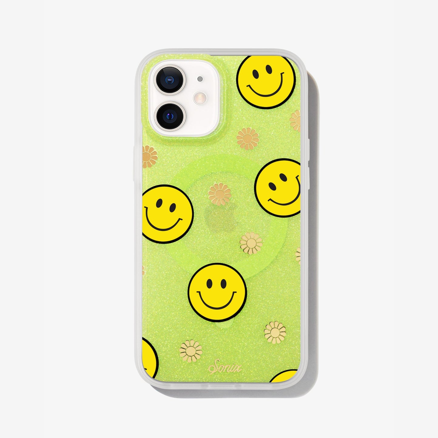 The clear yellow case infused with iridescent glitter features happy faces and signature gold foil flowers shown on an iphone