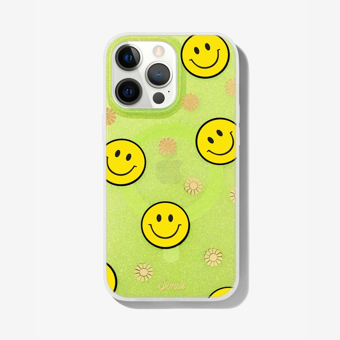 The clear yellow case infused with iridescent glitter features happy faces and signature gold foil flowers shown on an iphone