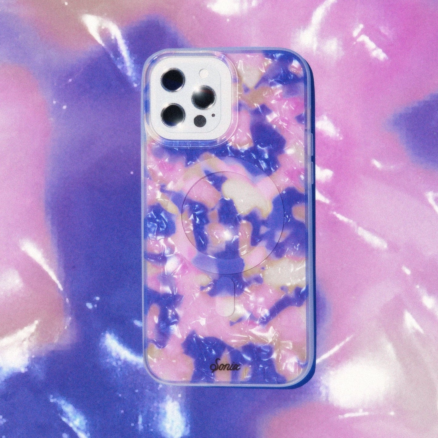 hazy illusion of pink, purple, and orange to create an appearance of a colorful mirage shown on an iphone with a purple blue and orange background