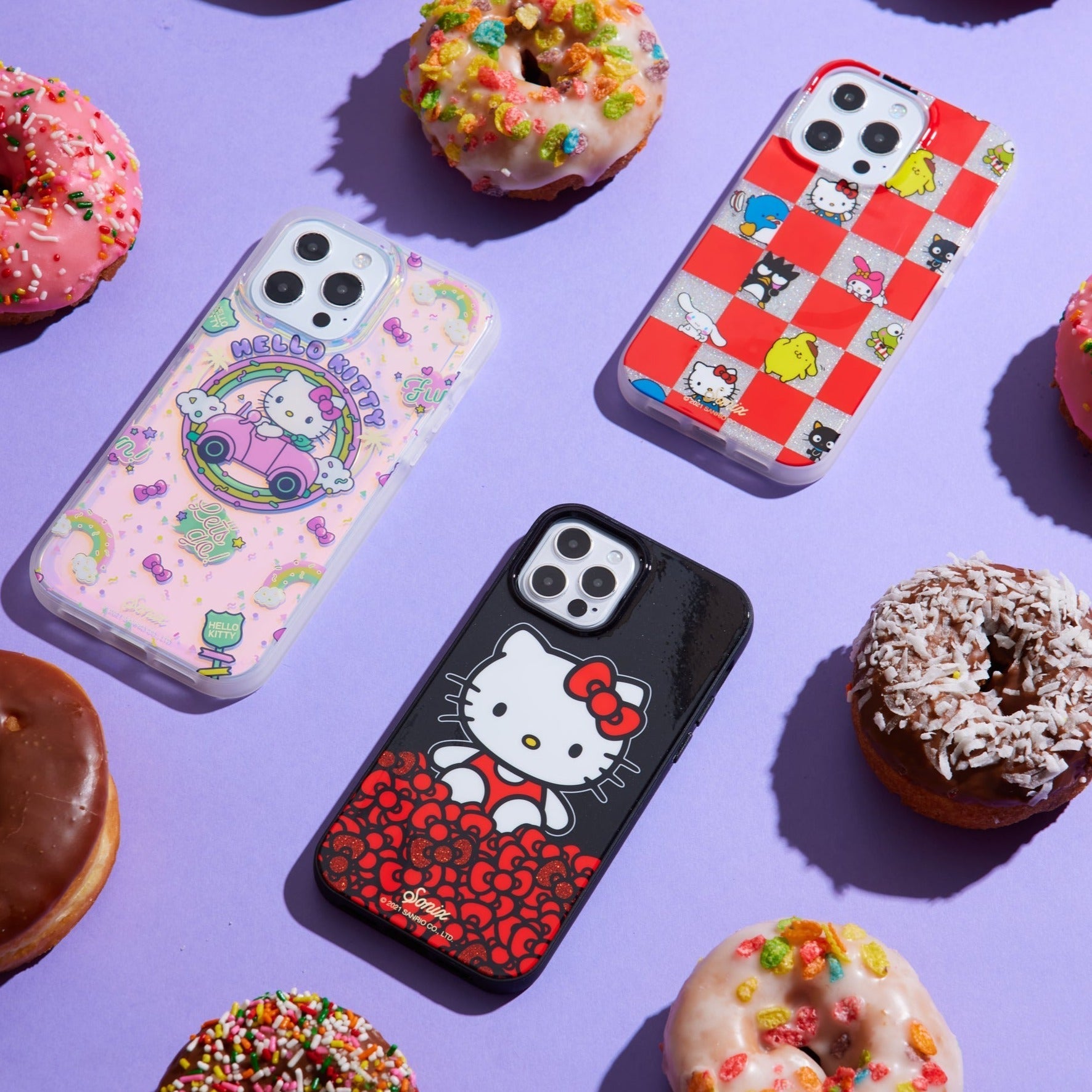 three hello kitty themed cases with a purple background and donuts