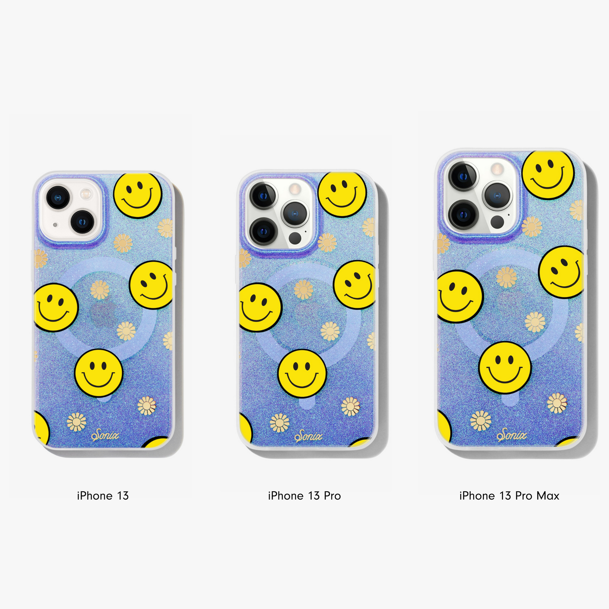The clear purple case infused with iridescent glitter features happy faces and signature gold foil flowers shown on an iphone 13, iphone 13 pro, and iphone 13 pro max