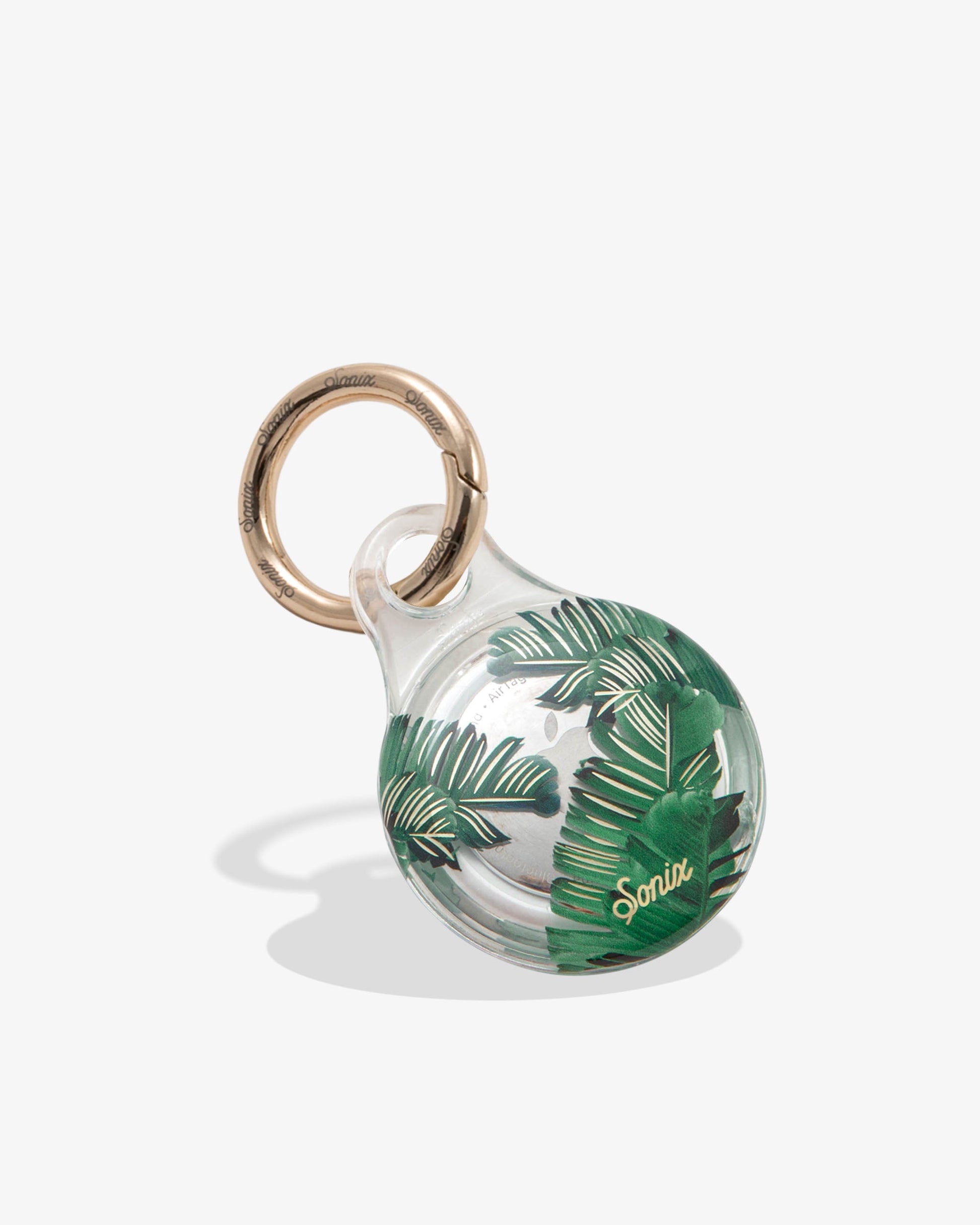 clear airtag case with green palm leaves with gold foil detail