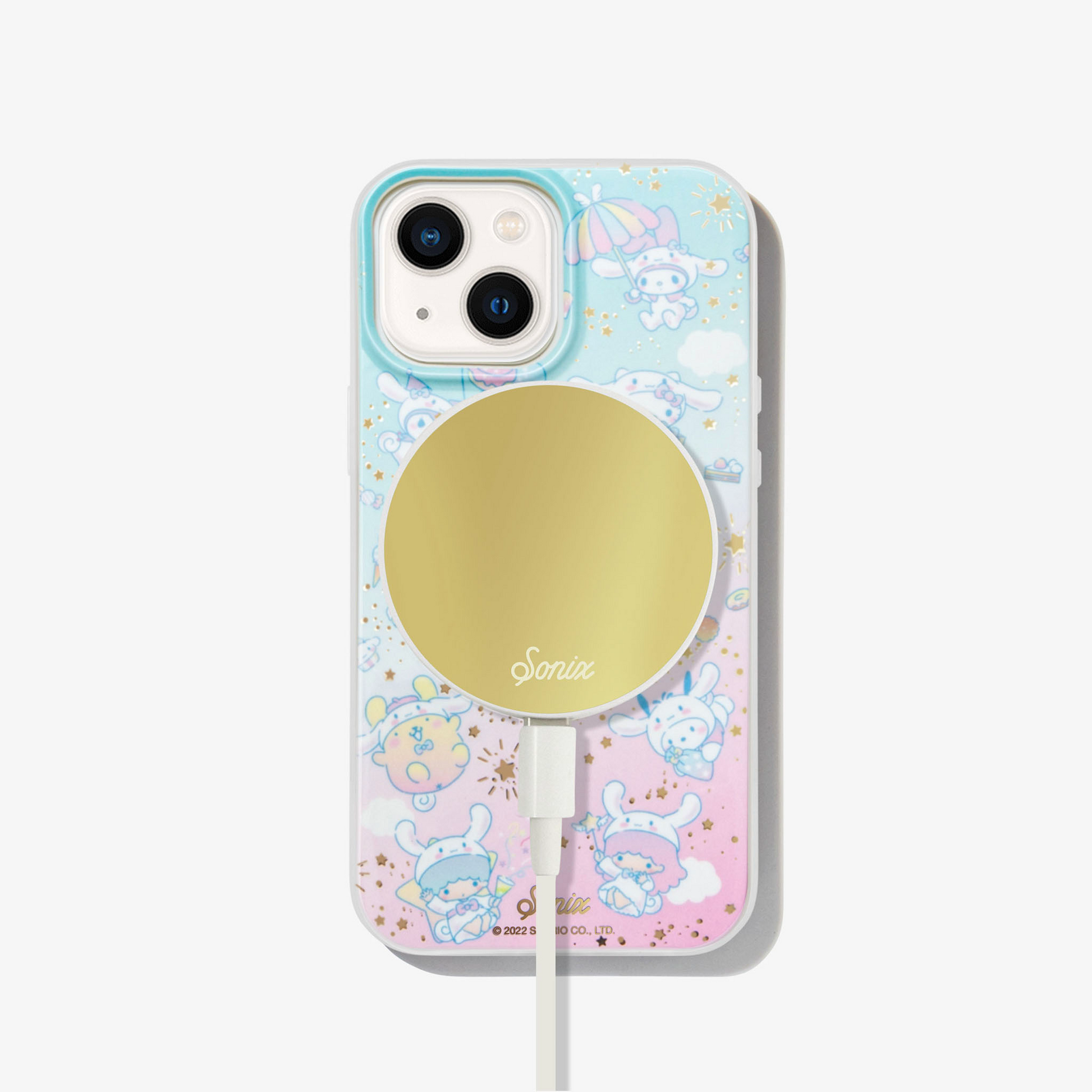 Pink and blue iphone case with gold stars, clouds, and hello kitty character cinnamoroll on an iphone 13 with a gold magsafe charger attached