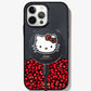 black glitter and Hello Kitty sitting on a bundle of her iconic red bows shown on a iphone 12 pro with a hello kitty magnetic link charger attached to the back 