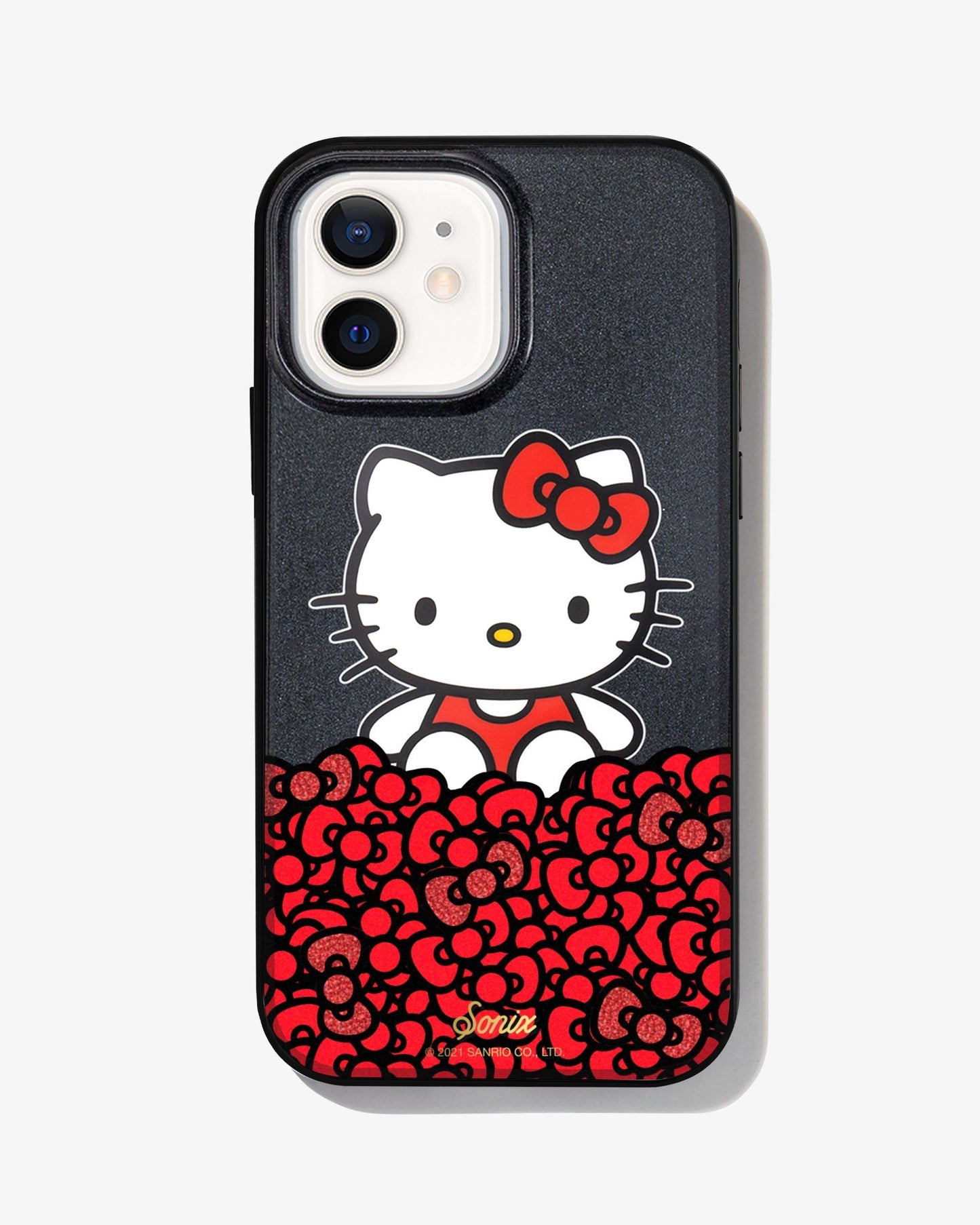 black glitter and Hello Kitty sitting on a bundle of her iconic red bows shown on a iphone 12