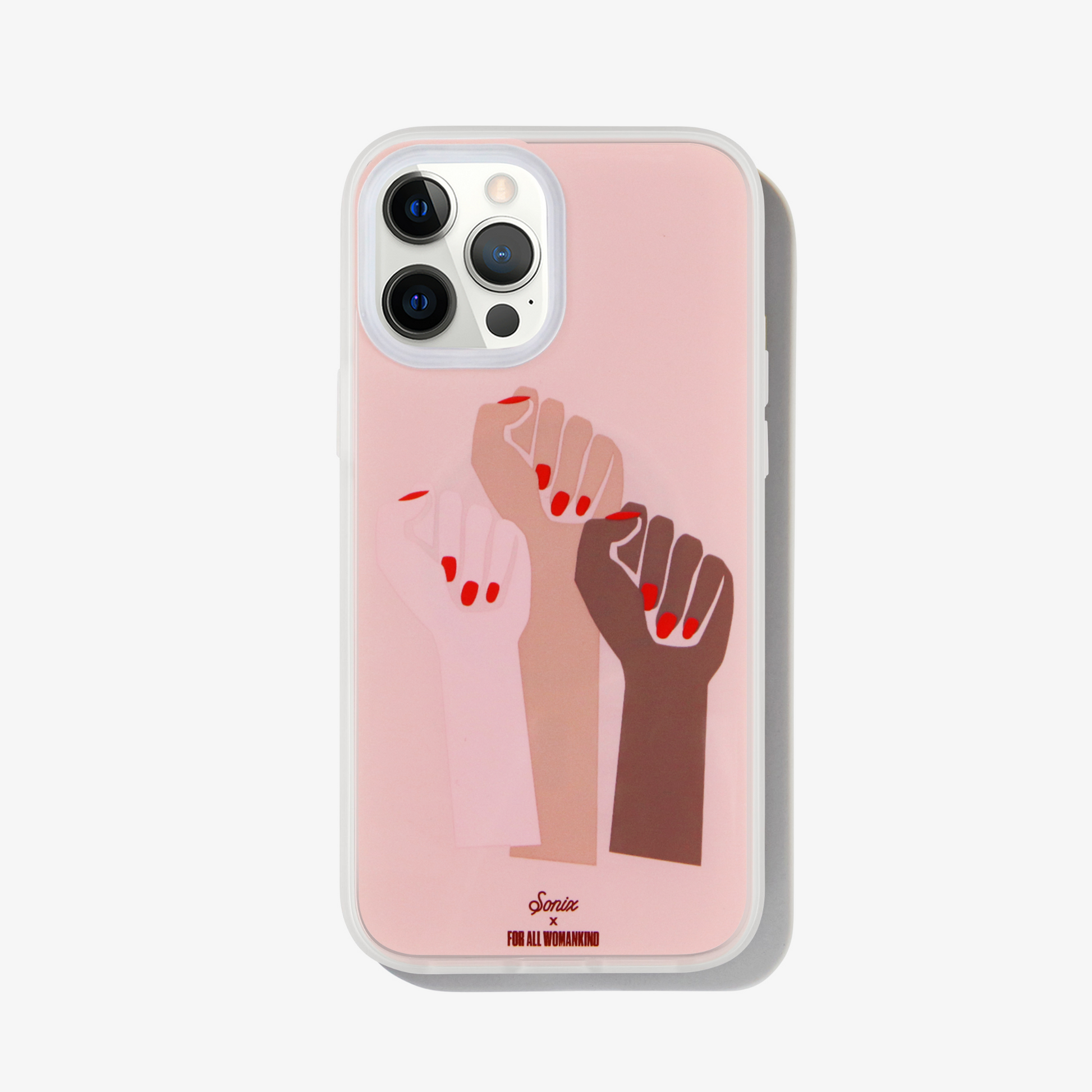 three fists with red nail polish on a pink background shown on an iphone 12 pro