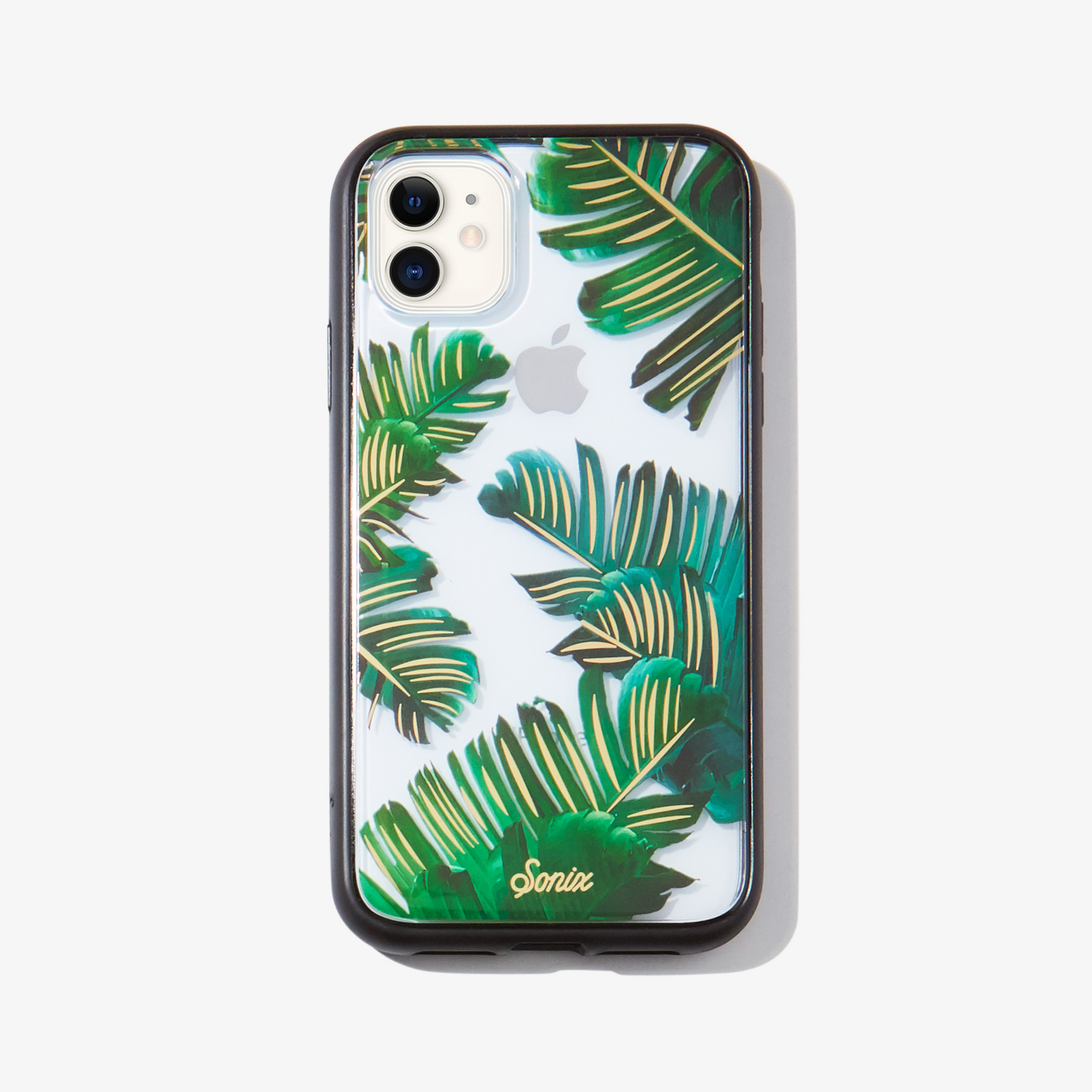 Bahama palm leaves iPhone 11 phone case on white phone.